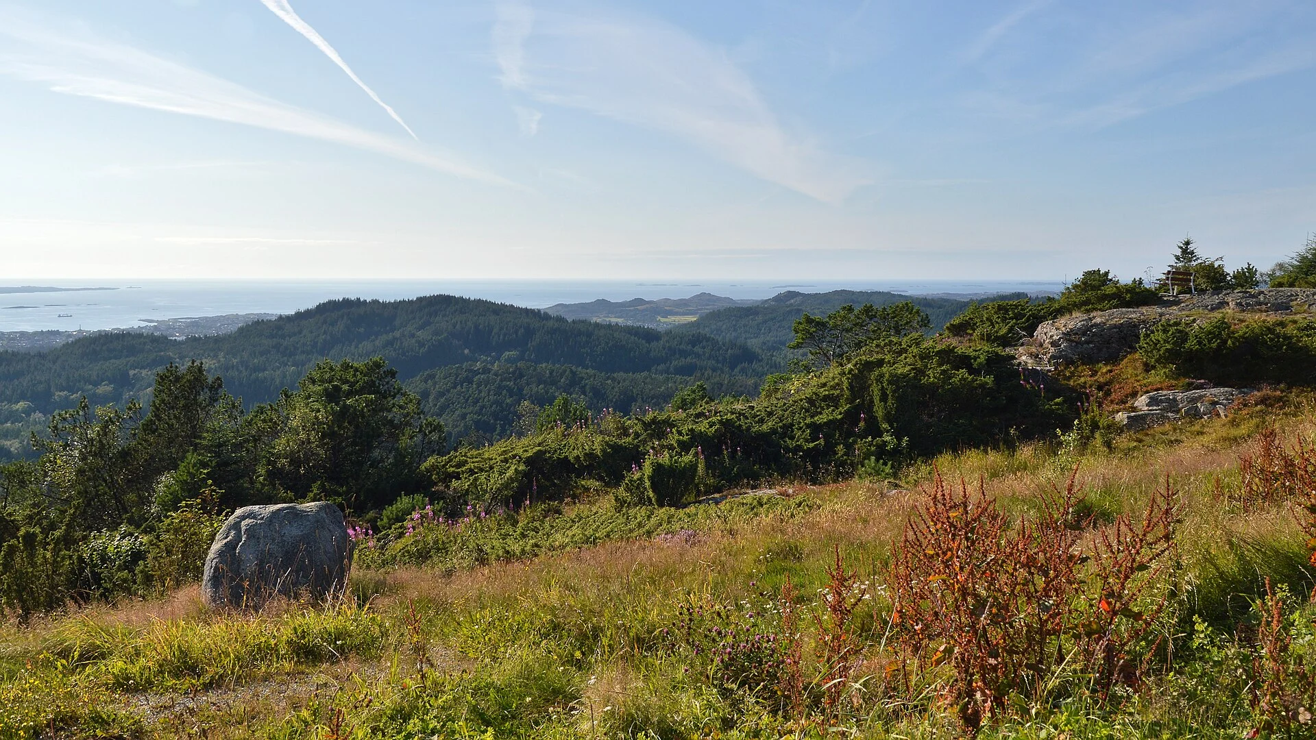Weiter Blick vom Steinsfjellet über Wälder auf Haugesund, den Karmsund und das offene Meer.
