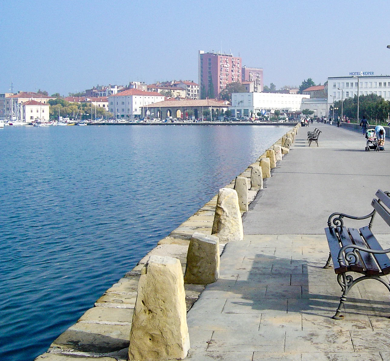 Die Uferpromenade von Koper mit Booten und der Stadt dahinter